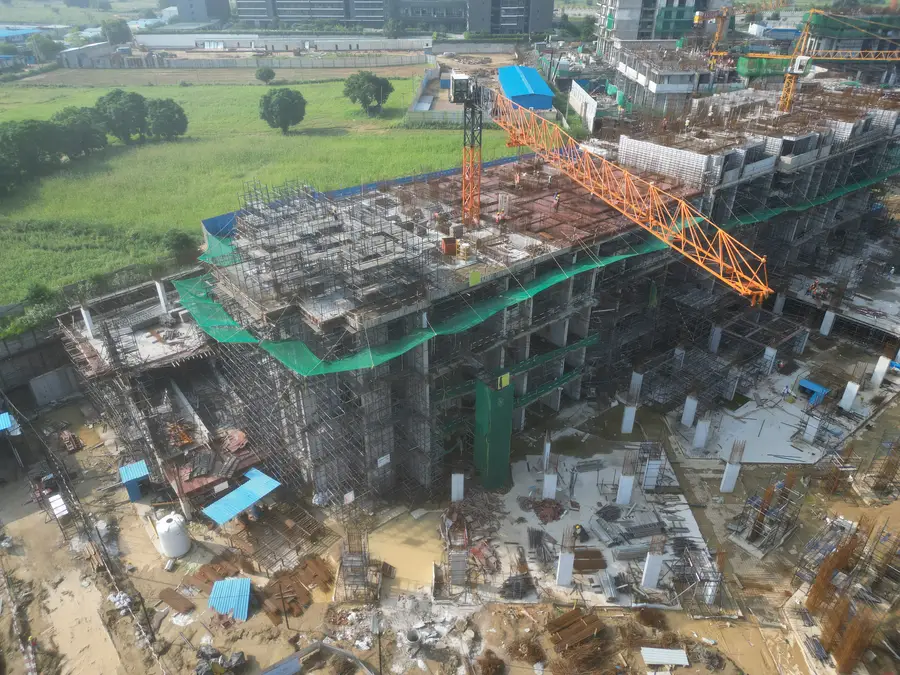 Aerial view of the construction site with a tower crane